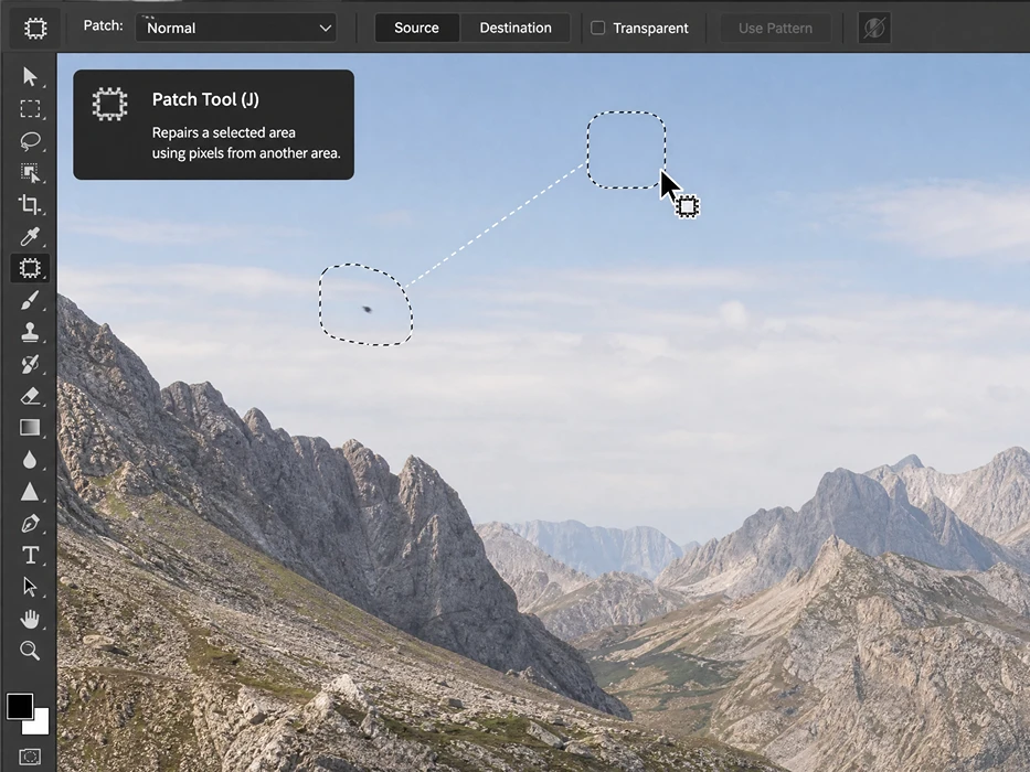 Close-up demonstration of the Photoshop Patch Tool repairing a small artifact in an expanded sky background.